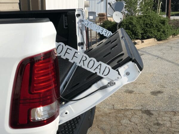 The back end of a white truck with a license plate