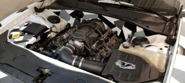 The engine compartment of a car with the hood up