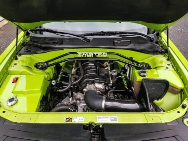 The engine compartment of a car with the hood open