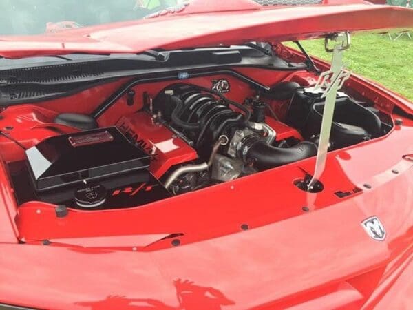 The engine compartment of a red sports car