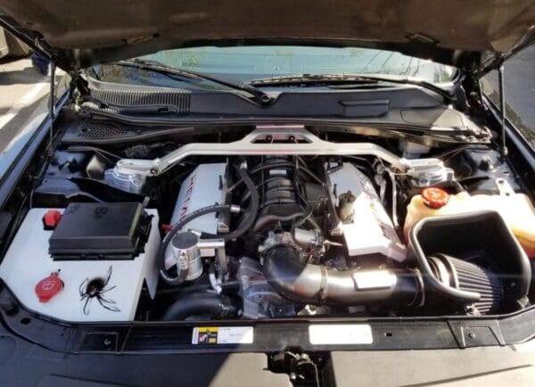 The engine compartment of a car with the hood open