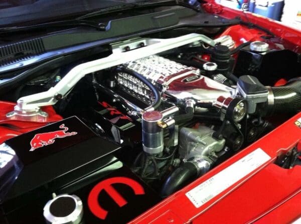 The engine compartment of a red sports car