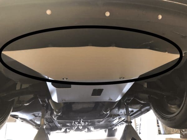 The underside of a car with a black circle around it