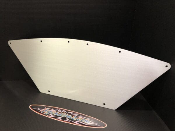 Silver triangular metal sheet with multiple holes against a black background.