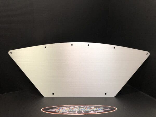 Brushed metal triangular plate with holes, set against a dark background.