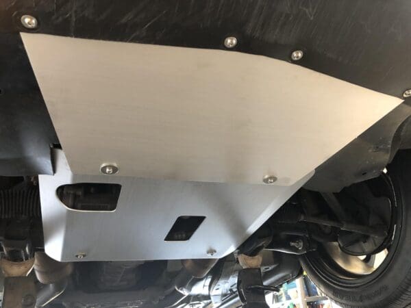 Undercarriage skid plate installed for vehicle protection.