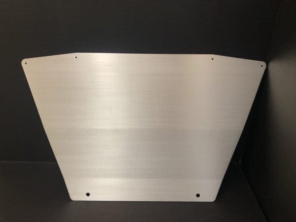 Brushed metal panel with rounded corners and drilled holes.