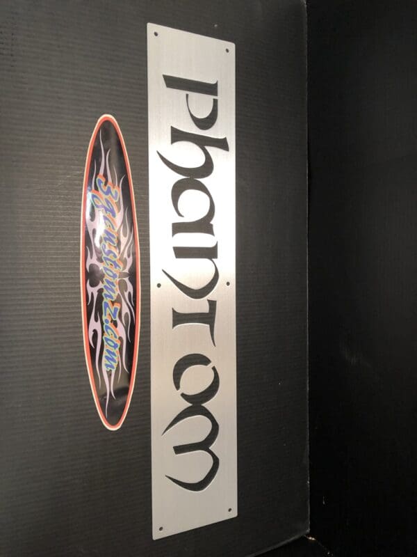 Decorative skateboards mounted on a black wall with 'Thrasher' logo.