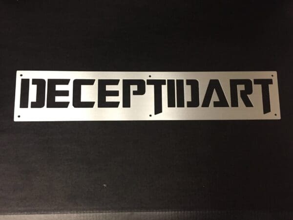 Metal informational sign with ambigram of the word "DECEPTIDART" that reads the same upside down.