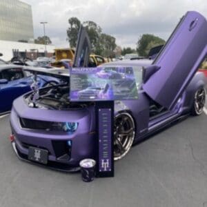 A purple car with its hood open in a parking lot