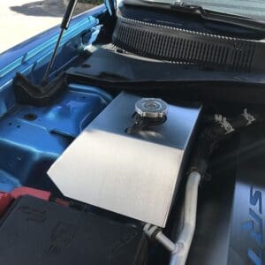 The engine compartment of a blue car with its hood open