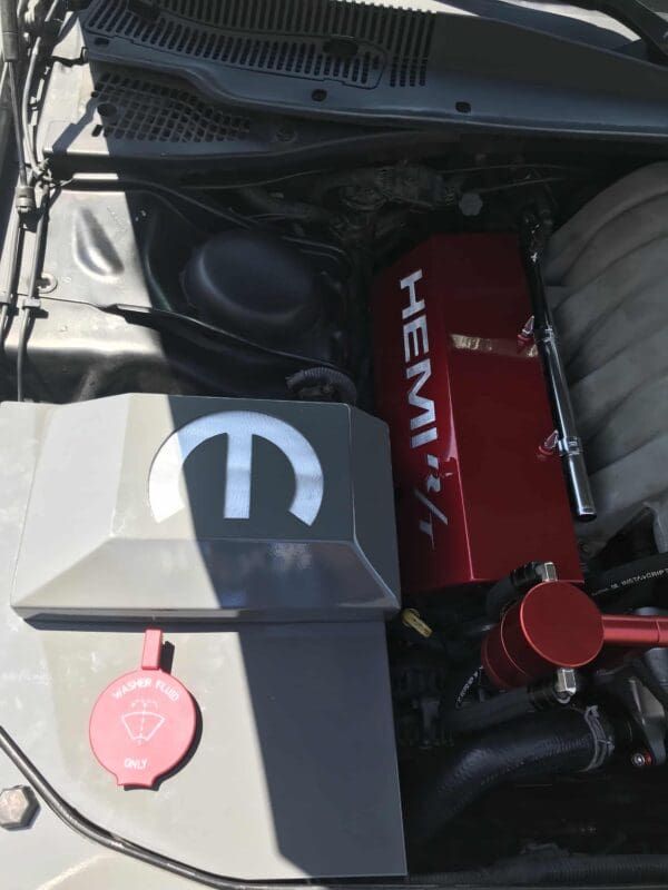 The engine compartment of a car with its hood open