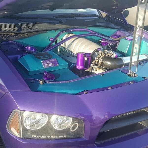 A purple sports car with its hood open