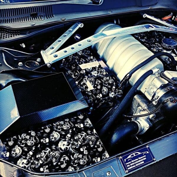 The engine compartment of a car is shown