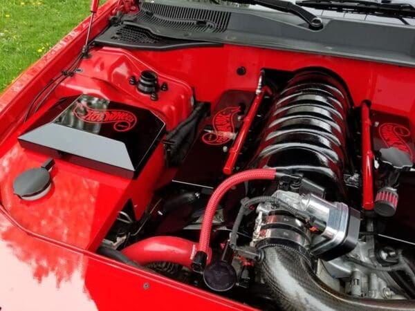 The engine compartment of a red sports car