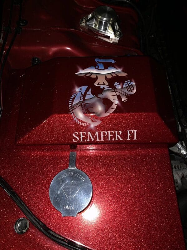 A close up of the emblem on a red vehicle