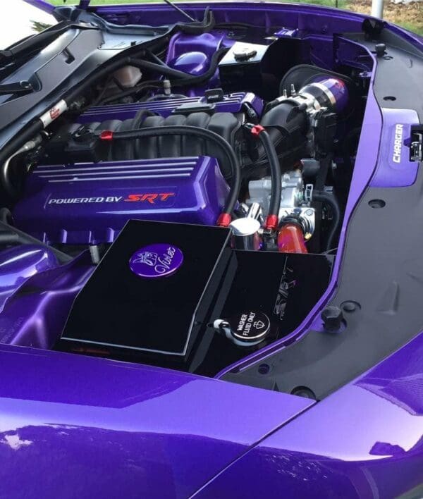 A purple sports car with its hood open