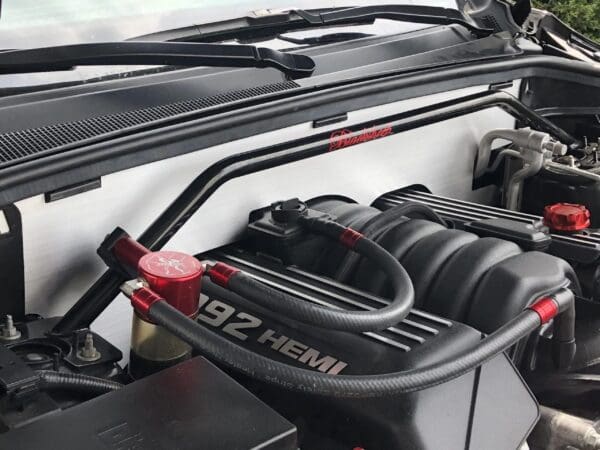 Open car hood revealing a 392 HEMI engine with custom red accents and a "Black Sheep" label on the back panel.