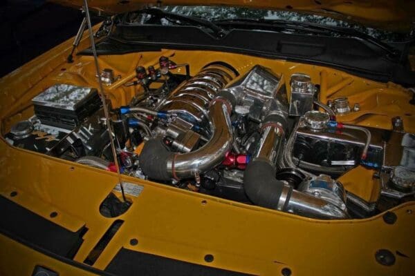 The engine compartment of a yellow sports car