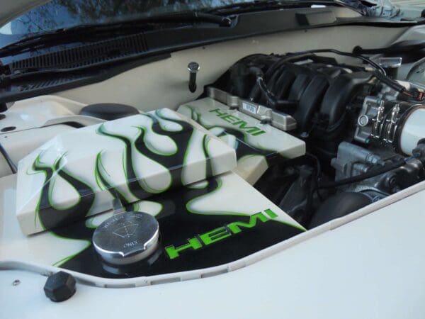 The engine compartment of a car with a green and white design on it