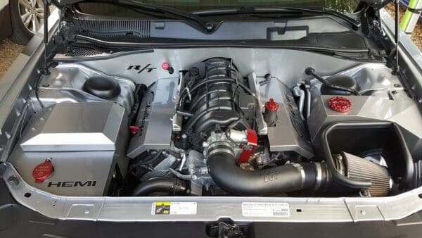 The engine compartment of a car is shown