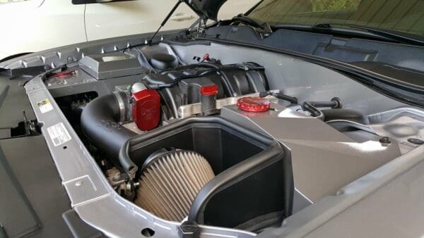 The engine compartment of a car with its hood open