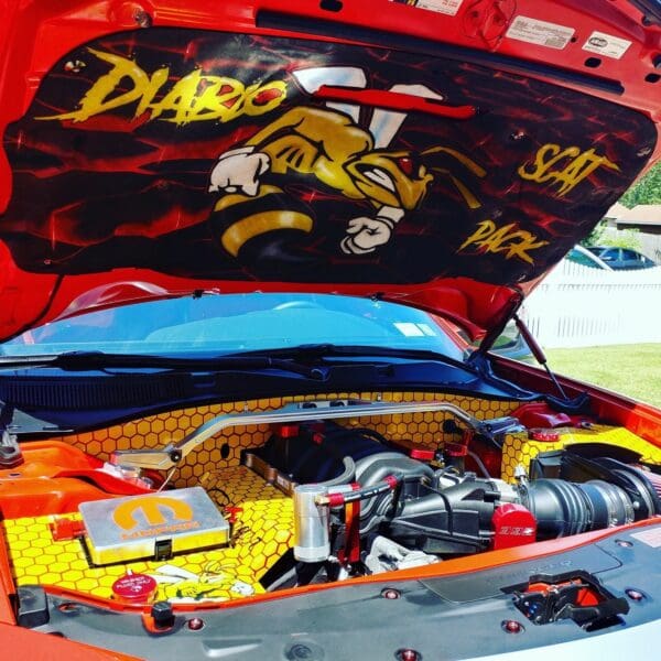 The engine compartment of a car with the hood open