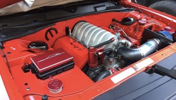 The engine compartment of a red sports car