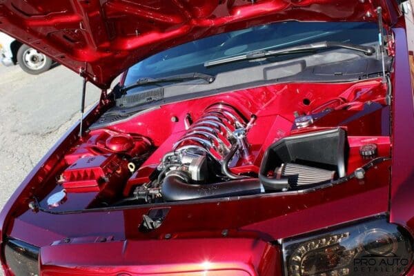 A close up of a red car engine