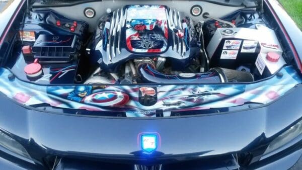 The hood of a sports car with a bunch of items in it