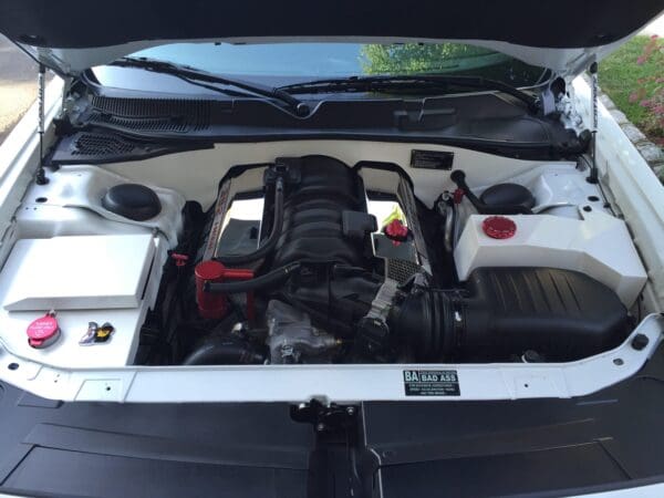 The engine compartment of a car with its hood open