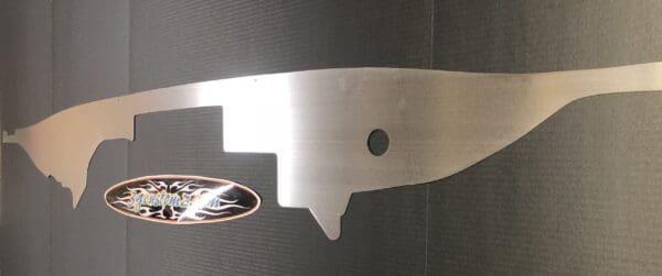 Close-up of a metallic object mounted on a wall, featuring the logo "3gzcustomz.com" with a flame design.