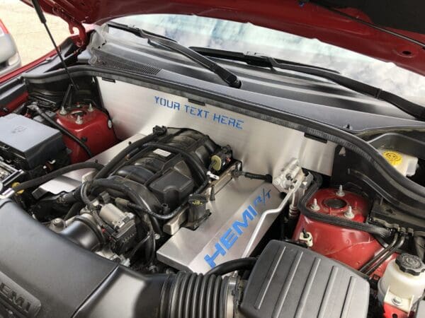 Car engine with hood open, featuring a custom panel labeled "YOUR TEXT HERE" and "HEMI R/T" in blue.