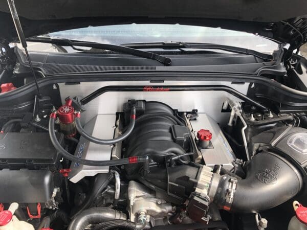 The engine of a car with its hood open