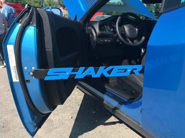 A close up of a car door with the word shaker on it