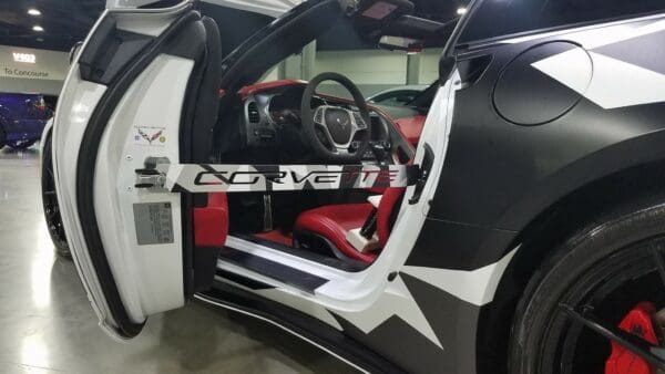 A car with its doors open in a showroom