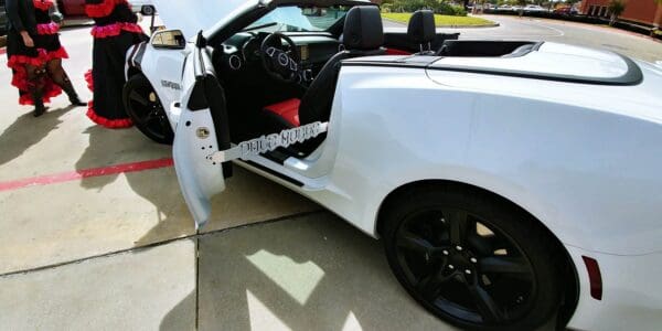 A white sports car with its door open