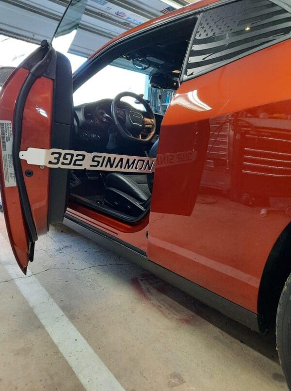 An orange van parked in a garage with its door open