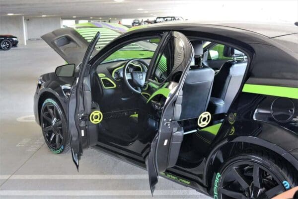 A car with its door open in a parking garage