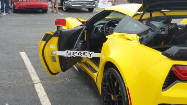 A yellow sports car parked in a parking lot