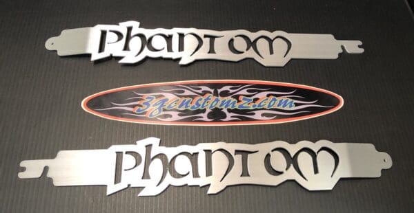 Three metal name plates on a table