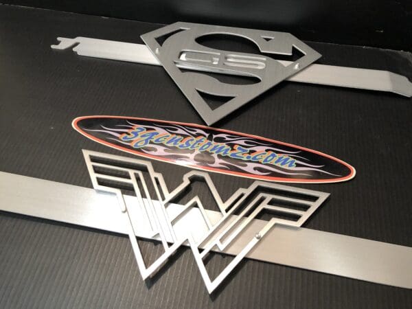 A close up of a superman logo on a table