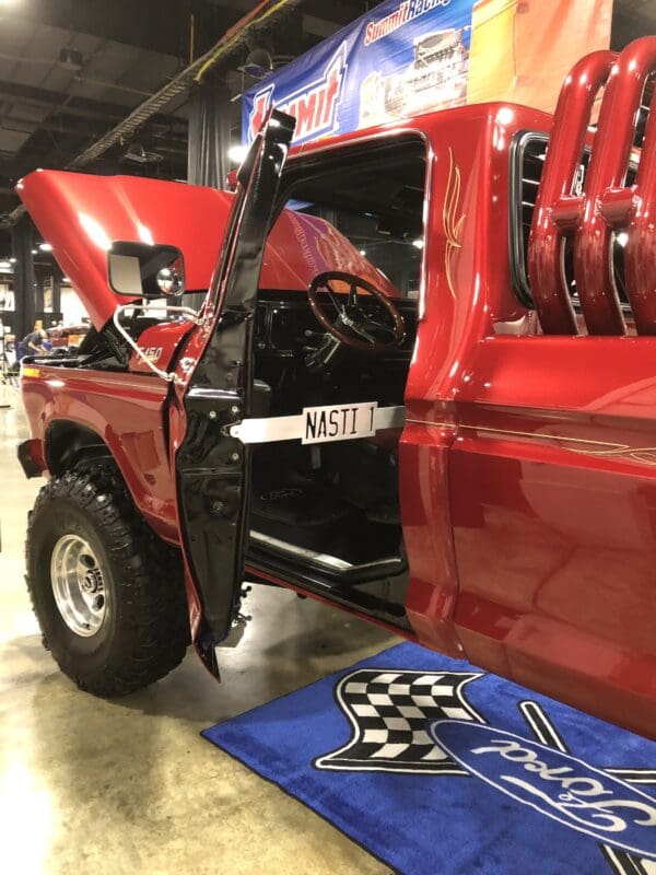 A red pick up truck parked inside of a garage