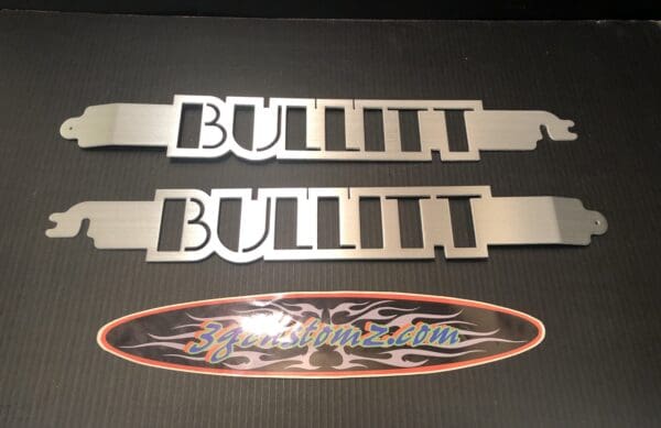 A couple of metal name plates on top of a table