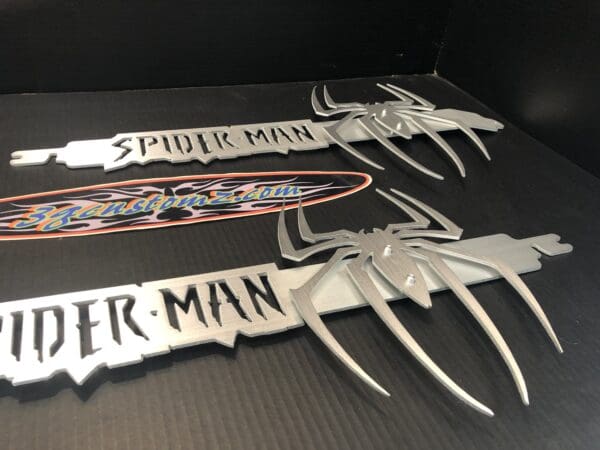 A set of four spider man knives sitting on top of a table