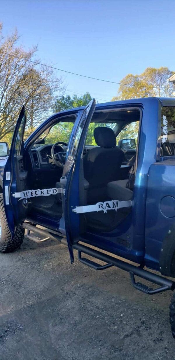 A blue pick up truck with its doors open