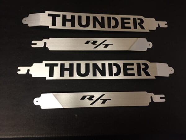 A set of three thunder emblems sitting on top of a table