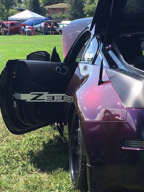 A purple sports car with its door open