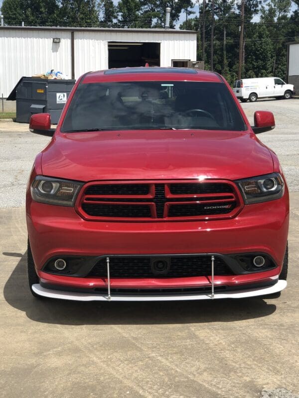 A red dodge charger parked in a parking lot