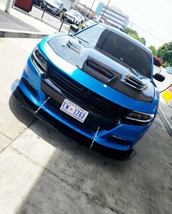 A blue car parked on the side of the road